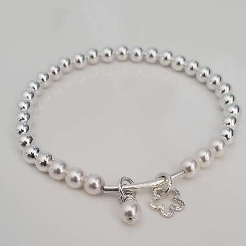 Silver beaded bracelet on a light gray background