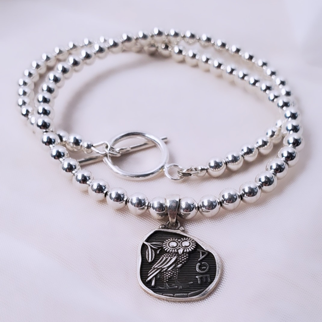 Picture of Sterling Silver Owl Powerful Necklace featuring the Owl of Athena pendant. This necklace symbolizes wisdom and intuition, making it a thoughtful graduation gift or a special treat for yourself.