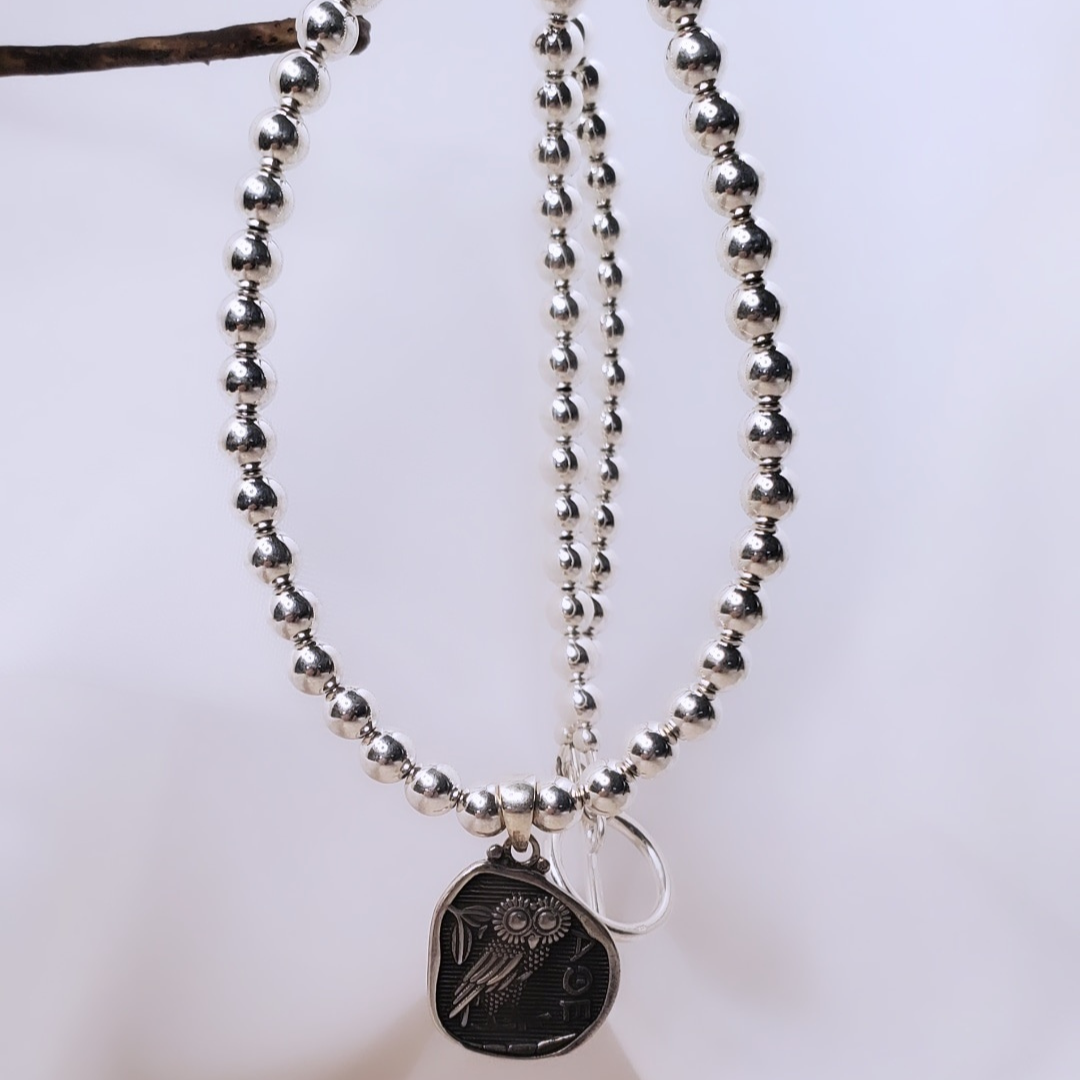 Picture of Sterling Silver Owl Powerful Necklace featuring the Owl of Athena pendant. This necklace symbolizes wisdom and intuition, making it a thoughtful graduation gift or a special treat for yourself.