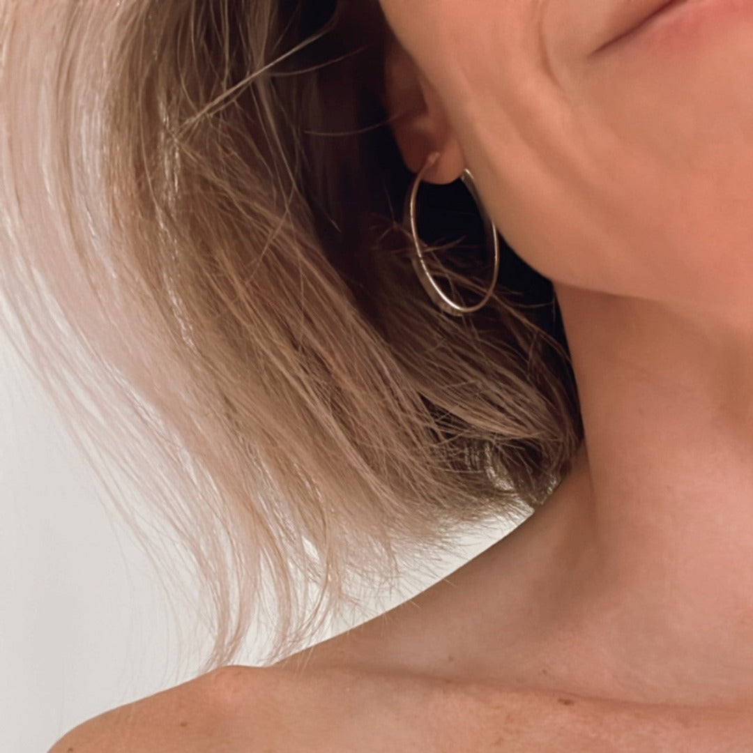 Introducing my Flat Oval Sterling Silver Hoops: timeless and versatile for everyday elegance. The smooth, flat oval shape adds polish to any outfit, perfect for various occasions with comfort and style. Ideal for solo statements or layered looks, these hoops embody effortless sophistication, maintained by regular cleaning and proper storage.