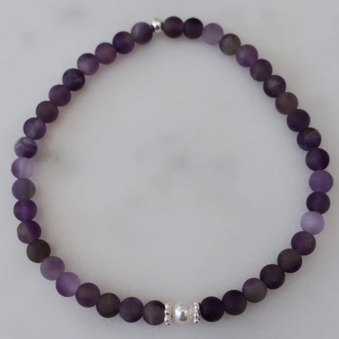 Introducing my Expandable 4mm Amethyst Gemstone Soothing Bracelet, a blend of elegance and calm. Featuring 4mm Amethyst gemstones for relaxation, Sterling Silver daisy spacers, and a 4mm Swarovski White Pearl for added grace. Wear it solo or mix and match with other Plein De Vie Jewelry bracelets to create your unique stack. Elevate your style and embrace tranquility with this exquisite piece.