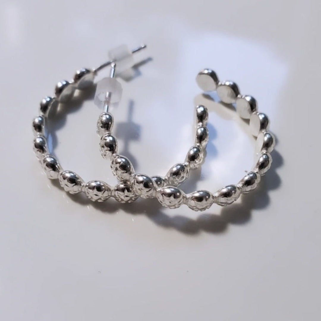 Introducing Sterling Silver Berry Dainty or Dynamic Hoops, the perfect addition to your everyday wardrobe. These versatile hoops feature a captivating berry-flower design, adding a touch of nature-inspired beauty to your look. Wear them alone or mix and match with other earrings to create a dynamic and personalized style.