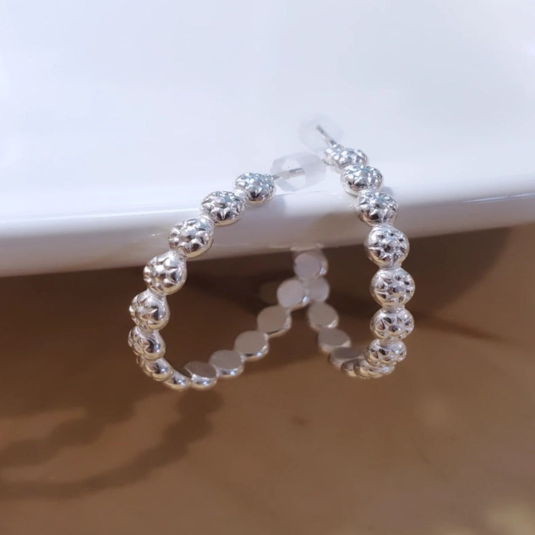 Introducing Sterling Silver Berry Dainty or Dynamic Hoops, the perfect addition to your everyday wardrobe. These versatile hoops feature a captivating berry-flower design, adding a touch of nature-inspired beauty to your look. Wear them alone or mix and match with other earrings to create a dynamic and personalized style.