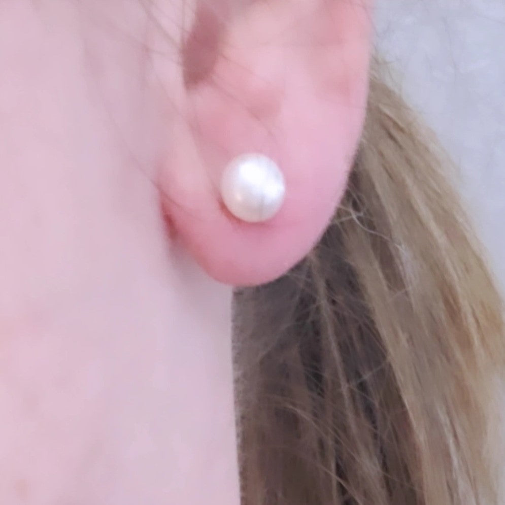 Eternal Elegance Pearl Studs featuring 8mm freshwater pearls on sterling silver rhodium plated posts. These classic earrings blend sophistication with versatility, perfect for any occasion. The pristine pearls capture light beautifully, enhancing natural radiance. Crafted with love and quality, they celebrate timeless beauty and life's special moments.