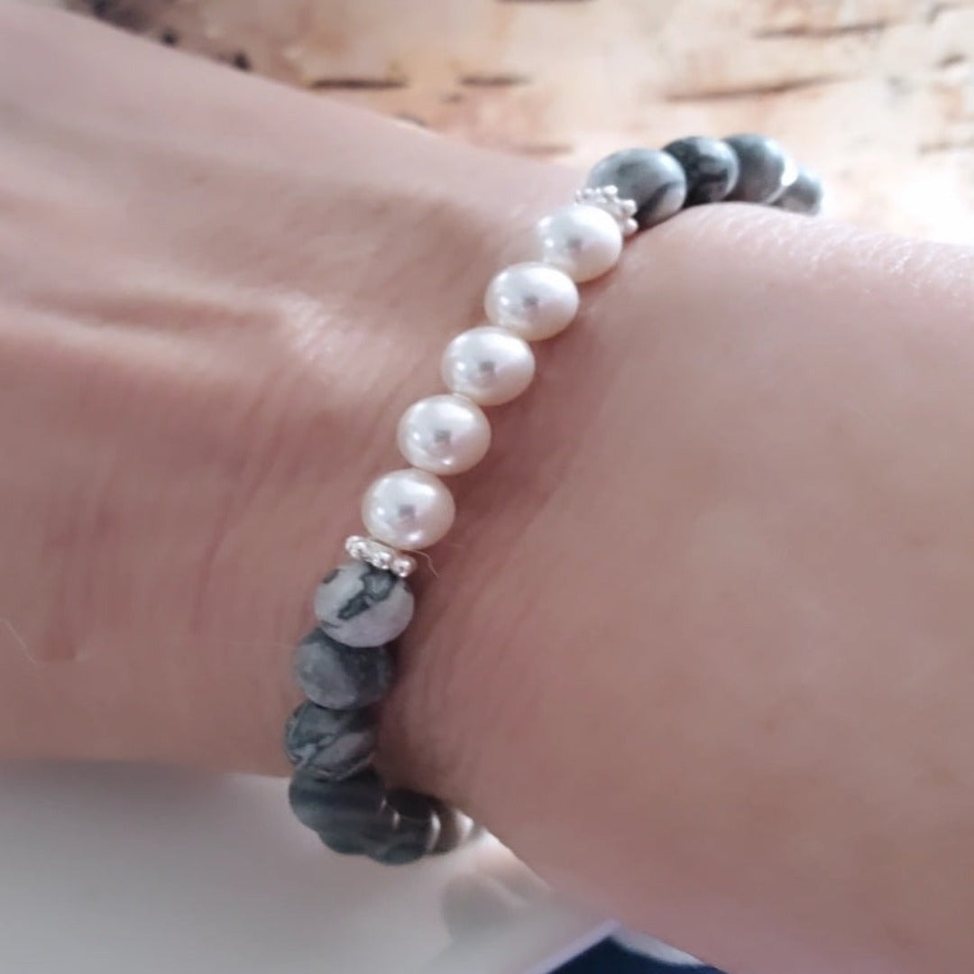 Introducing my 6mm Picture Jasper Gemstone and Swarovski Pearl Bracelet – crafted for elegance and tranquility. Picture Jasper soothes the soul, paired with Sterling Silver daisy spacers and Swarovski Pearls for timeless grace. Wear it solo or stacked for versatile elegance.