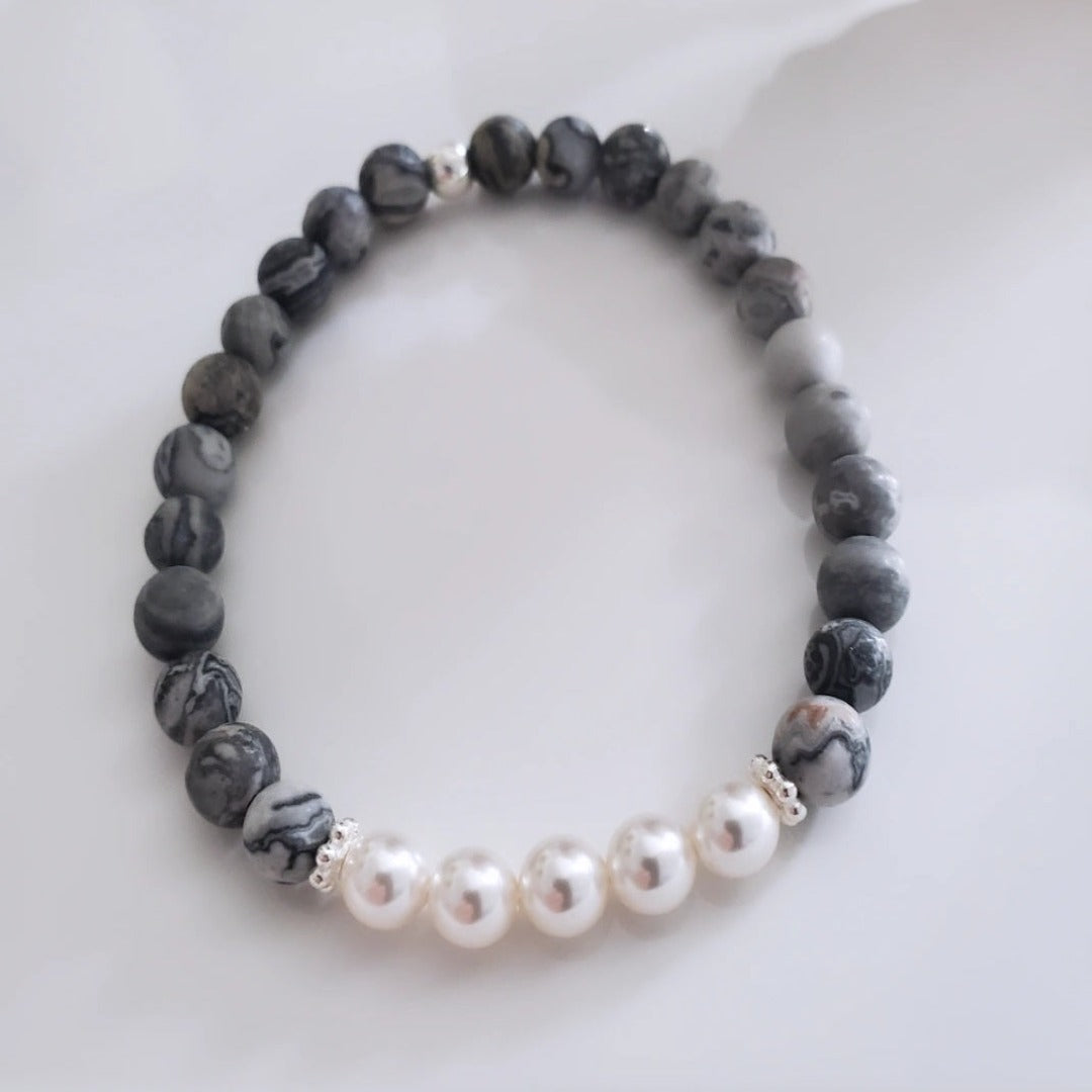 Introducing my 6mm Picture Jasper Gemstone and Swarovski Pearl Bracelet – crafted for elegance and tranquility. Picture Jasper soothes the soul, paired with Sterling Silver daisy spacers and Swarovski Pearls for timeless grace. Wear it solo or stacked for versatile elegance.