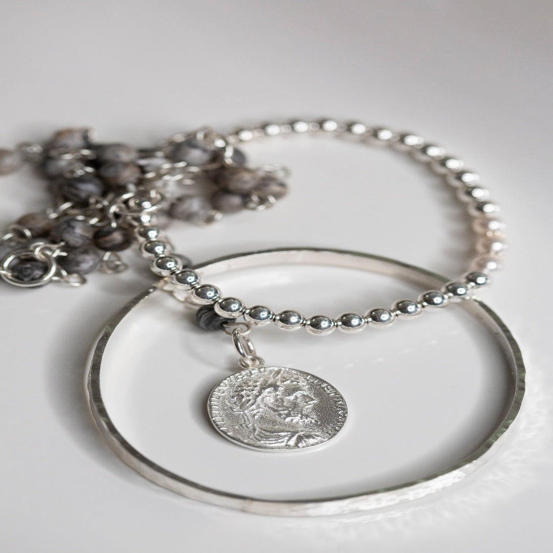 My Sterling Silver Rectangle Dimpled Bangle is handmade with a heavier gauge sterling silver and hammered for a dimpled look that catches the light beautifully. Wrap your wrist with style—why wear one when you can wear all three?