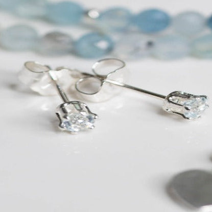 Aquamarine Sterling Silver Post Earrings: Everyday essential featuring serene light blue aquamarine gemstones. Associated with calmness, clarity, and communication, perfect for adding subtle color and sparkle to any outfit. Ideal for casual and formal occasions.