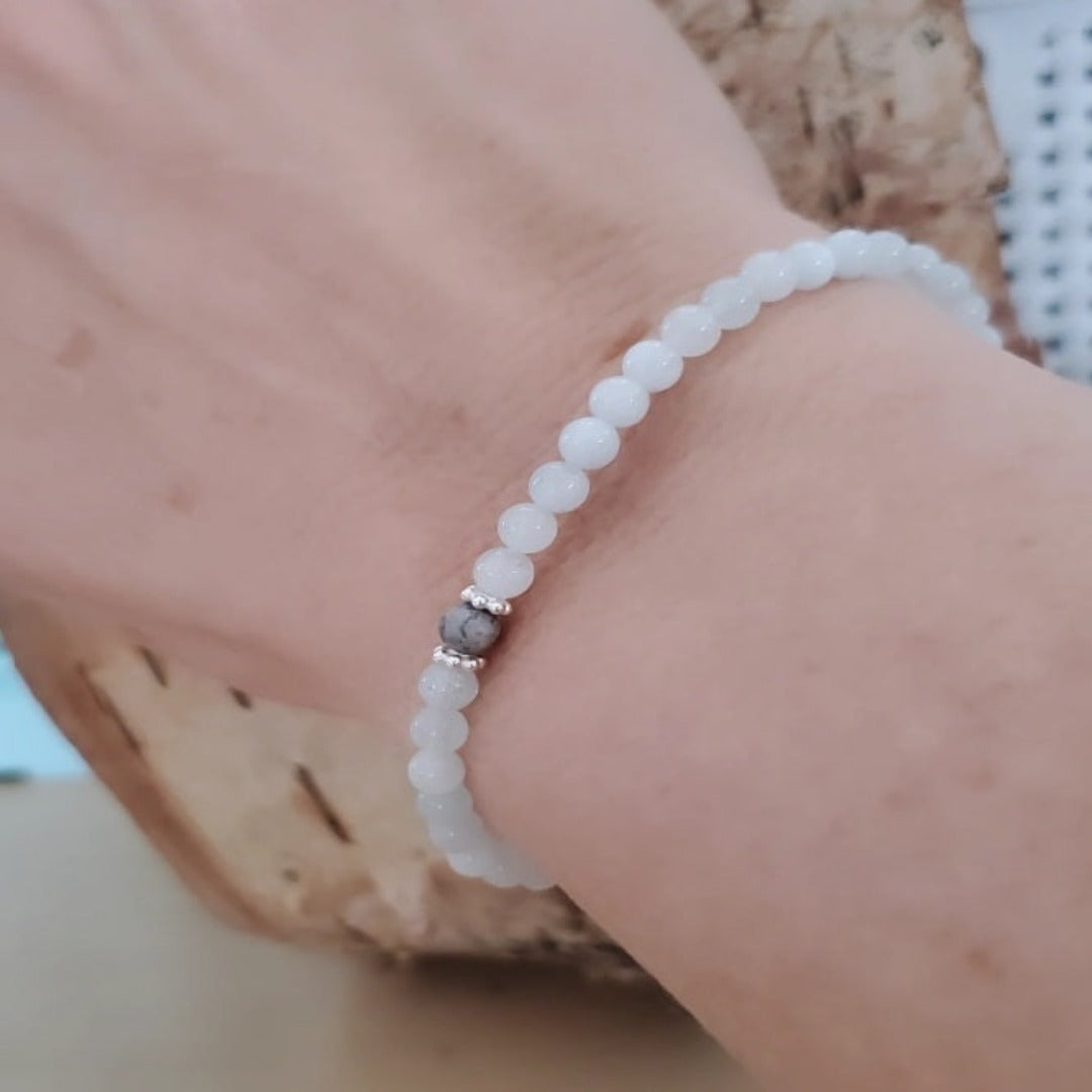 Introducing my Aquamarine Gemstone Sea of Blue Bracelet, embodying timeless elegance and serenity. The 4mm Aquamarine gemstones capture the ocean's tranquility, complemented by Sterling Silver daisy spacers for added sophistication. A 4mm matte Picture Jasper gemstone adds grounding qualities. Wear it solo or mix and match with other Plein De Vie Jewelry bracelets for a unique look.