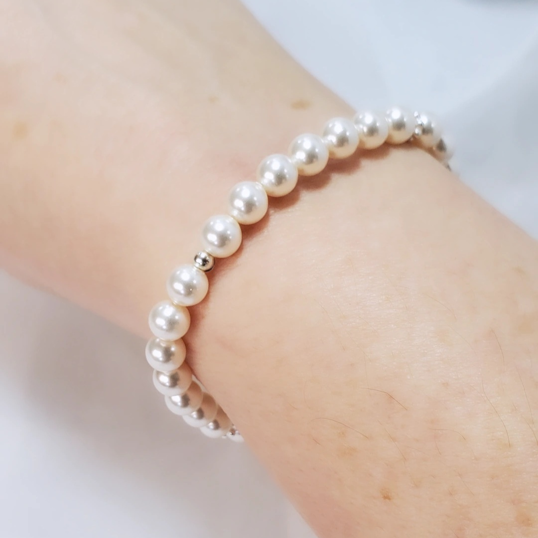Swarovski Pearl and Daisy Bracelet symbolizing Mother Nature’s nurturing and protection. Features daisy spacers reminiscent of Spring wildflowers, creating a timeless and classic look. Can be worn solo or layered with other Plein De Vie favorites.