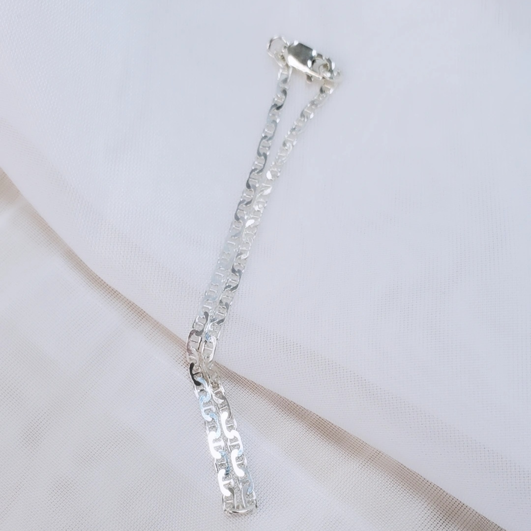Introducing my Sterling Silver Half Flat Oval Mariner Curb Bracelet, a timeless 7-inch piece exuding elegance and charm. Crafted with half flat oval links and a double heart charm, it adds a touch of love and sophistication. Wear it solo or layered with other Plein De Vie Jewelry bracelets for a unique style. Elevate your look with this versatile bracelet from Plein De Vie Jewelry.