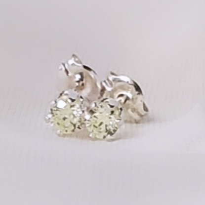 Sterling Silver Post Peridot Daily Bling Earrings: Vibrant accessories featuring peridot cubic zirconia gemstones, known for their lively green color and associations with vitality and joy. Perfect for adding a pop of color to everyday outfits. Classic post style closure ensures secure and comfortable wear.