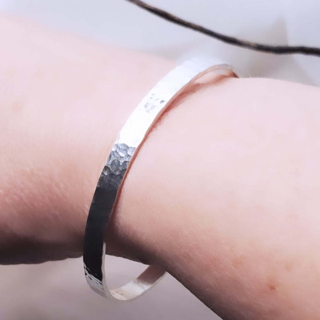 My Sterling Silver Rectangle Dimpled Bangle is handmade with a heavier gauge sterling silver and hammered for a dimpled look that catches the light beautifully. Wrap your wrist with style—why wear one when you can wear all three?