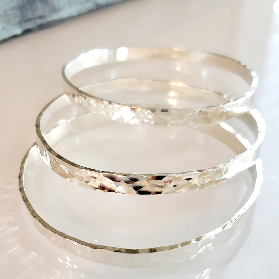 My Sterling Silver Rectangle Dimpled Bangle is handmade with a heavier gauge sterling silver and hammered for a dimpled look that catches the light beautifully. Wrap your wrist with style—why wear one when you can wear all three?