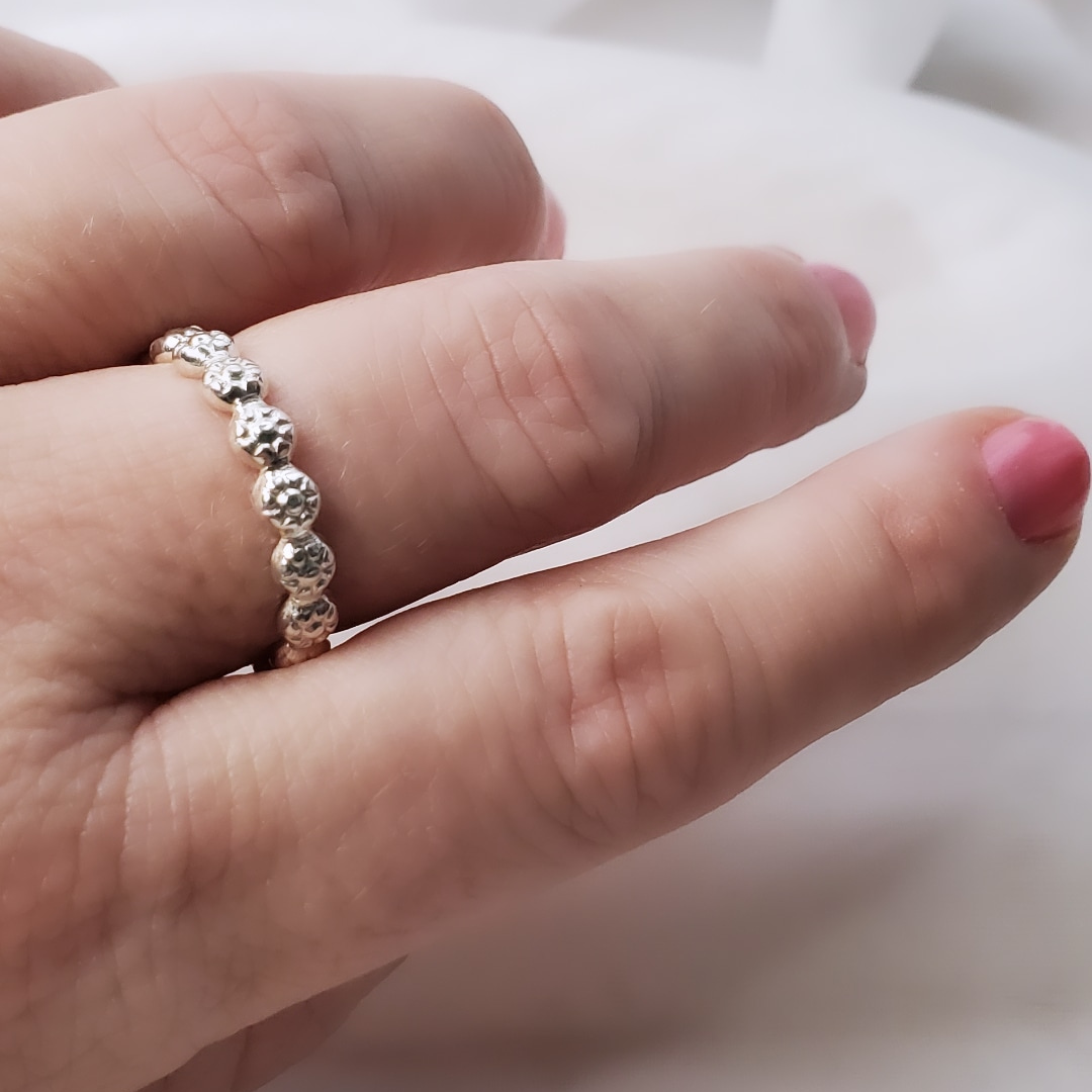 Sterling Silver Berry Dainty or Dynamic Rings featuring interlocking berry-flower designs. These versatile rings can be stacked together for a bold look or worn individually for a minimalist style. Perfect for everyday wear, they offer endless possibilities for creative expression and fashion-forward statements.