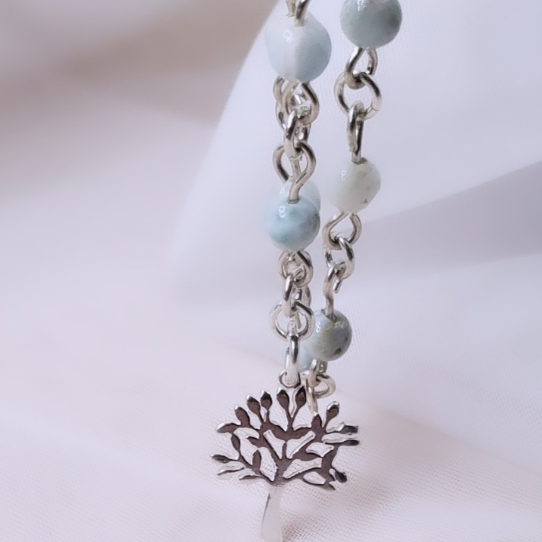 Picture of Sterling Silver Larimarvelous Necklace featuring a sterling silver tree pendant and gentle-energy larimar gemstones. This necklace symbolizes higher wisdom, healing, and manifestation, while larimar promotes a natural state of vitality and connection with nature.