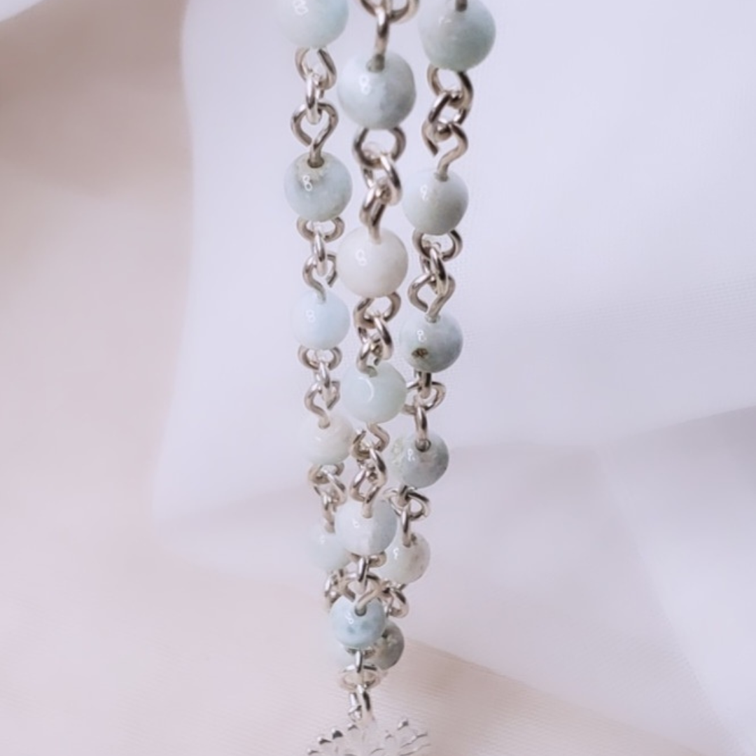 Picture of Sterling Silver Larimarvelous Necklace featuring a sterling silver tree pendant and gentle-energy larimar gemstones. This necklace symbolizes higher wisdom, healing, and manifestation, while larimar promotes a natural state of vitality and connection with nature.