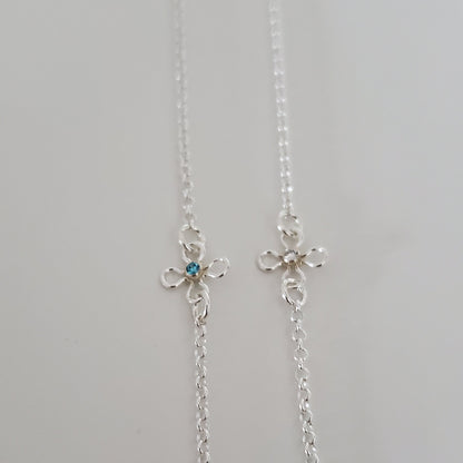 Delicate sterling silver flower bracelet with a bezel set cubic zirconia