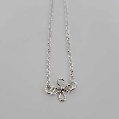 Floral sterling silver bracelet with a flower charm and blue topaz CZ accent