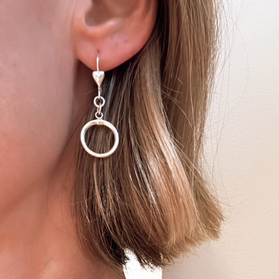 Introducing my Sterling Silver Heart Leverback Circle of Love Earrings: a beautiful symbol of love and affection. With a secure leverback closure for comfort, these earrings feature a heart-shaped design, representing eternal love and connection. Perfect for everyday wear or special occasions, they make a sentimental addition to your jewelry collection.