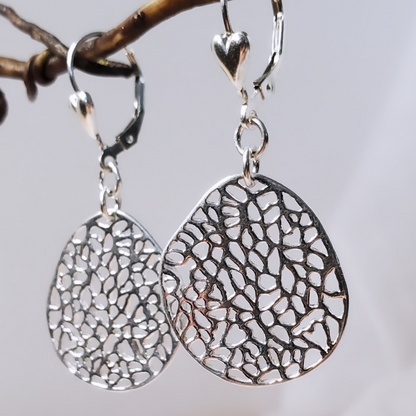 Introducing my Sterling Silver Leverback Filigree Fantasy Earrings: a must-have for everyday elegance.  Featuring large oval filigree pendants suspended from sterling silver heart leverbacks, these earrings evoke the vintage charm of antique lace. Crafted from durable sterling silver, they offer a radiant and versatile accessory for any occasion.