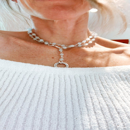 Picture of the handmade Sterling Silver Aquamarine Necklace "BELIEVE." This 31" necklace features genuine aquamarine round gemstones linked with 20g sterling silver, secured with a lobster clasp. The washer-style pendant stamped with "BELIEVE" adds a meaningful touch, symbolizing authenticity, growth, love, inspiration, education, integrity, and joy. Wear it as a regular necklace or transform it into a lariat style to accentuate your style and remind yourself of these powerful principles.