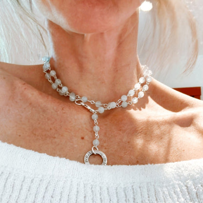 Picture of the handmade Sterling Silver Aquamarine Necklace "BELIEVE." This 31" necklace features genuine aquamarine round gemstones linked with 20g sterling silver, secured with a lobster clasp. The washer-style pendant stamped with "BELIEVE" adds a meaningful touch, symbolizing authenticity, growth, love, inspiration, education, integrity, and joy. Wear it as a regular necklace or transform it into a lariat style to accentuate your style and remind yourself of these powerful principles.