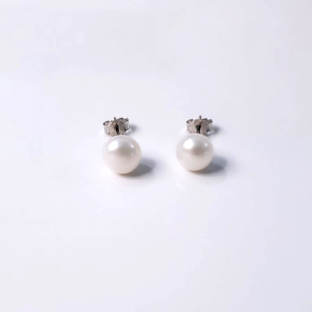 Indulge in the timeless allure of Eternal Elegance Pearl Studs, featuring 8mm freshwater pearls on sterling silver rhodium-plated posts. These versatile earrings blend sophistication and versatility, perfect for any occasion. Crafted with love, they celebrate classic beauty and elevate any outfit with understated elegance