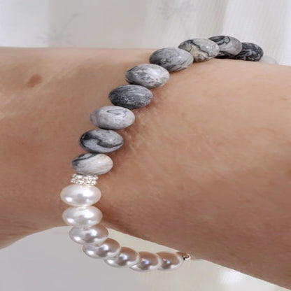 Introducing my 6mm Picture Jasper Gemstone and Swarovski Pearl Bracelet – a blend of timeless elegance and inner calm. Crafted with precision and passion, it adorns your wrist with luxury and serenity.  Picture Jasper reveals beauty in the unnoticed, paired with Sterling Silver daisy spacers for sophistication. A 6mm Swarovski White Pearl adds timeless grace.  Wear it solo for refined elegance or mix and match for a unique stack. Elevate your style with Plein De Vie Jewelry.