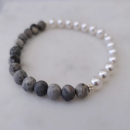 Introducing my 6mm Picture Jasper Gemstone and Swarovski Pearl Bracelet – a blend of timeless elegance and inner calm. Crafted with precision and passion, it adorns your wrist with luxury and serenity.  Picture Jasper reveals beauty in the unnoticed, paired with Sterling Silver daisy spacers for sophistication. A 6mm Swarovski White Pearl adds timeless grace.  Wear it solo for refined elegance or mix and match for a unique stack. Elevate your style with Plein De Vie Jewelry.
