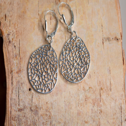 Introducing my Sterling Silver Leverback Filigree Fantasy Earrings: a must-have for everyday elegance.  Featuring large oval filigree pendants suspended from sterling silver heart leverbacks, these earrings evoke the vintage charm of antique lace. Crafted from durable sterling silver, they offer a radiant and versatile accessory for any occasion.
