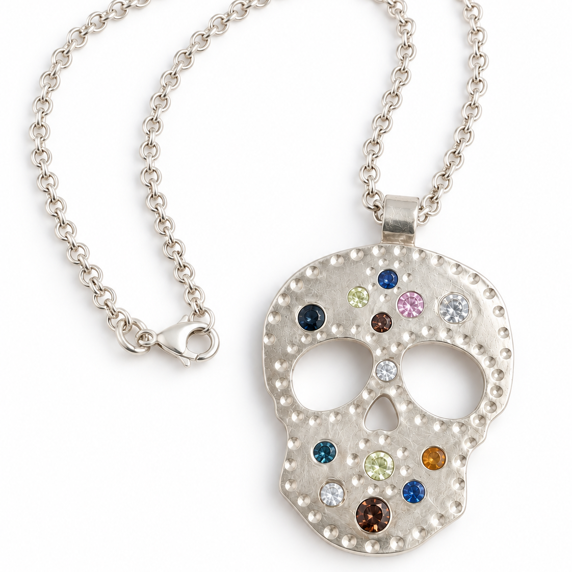 A silver sugar skull pendant necklace adorned with colorful cubic zirconia and gemstones, displayed on a clean white background.