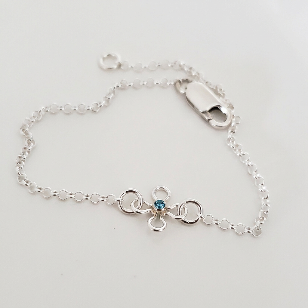 Sterling silver Bloom & Sparkle bracelet with a blue cubic zirconia flower charm