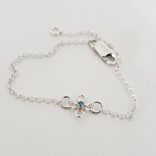 Sterling silver Bloom & Sparkle bracelet with a blue cubic zirconia flower charm