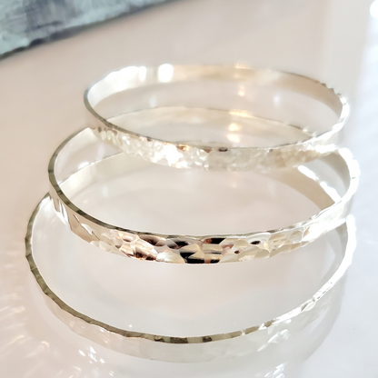 My Sterling Silver Rectangle Dimpled Bangle is handmade with a heavier gauge sterling silver and hammered for a dimpled look that catches the light beautifully. Wrap your wrist with style—why wear one when you can wear all three?